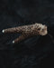 Leopard figurine on a dark textured surface