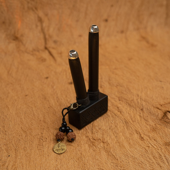Black electronic device with a keychain on a brown surface