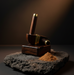 Wooden pestle and mortar with a small pile of powder on a dark surface