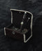 Decorative box with a black pen and silver accents on a textured black surface