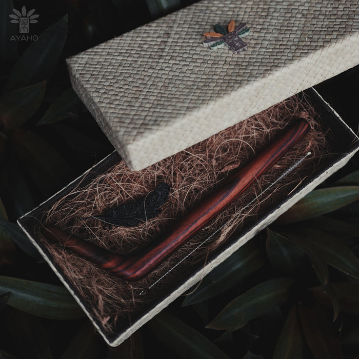 Wooden tools in a box with natural materials and Ayahuasca branding.