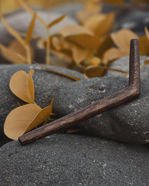 Wooden tool on a rock with autumn leaves in the background
