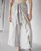 Luxurious silver Thai pants crafted from breathable silk-cotton blend, featuring artisanal stitching for a relaxed, stylish fit