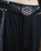 Black pants with a patterned waistband on a blurred background