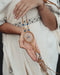 Close-up of a traditional-style dream catcher amulet with amethyst and howlite beadsx, hanging from a car mirror.