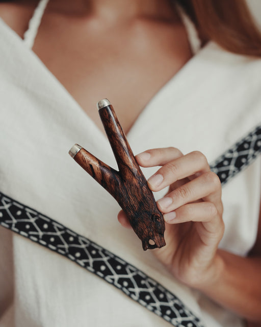 Person holding a wooden tool with a blurred background