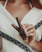 Person holding a wooden tool with a blurred background
