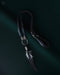 Black raven feather encased in resin with silver wire wrapping, hanging from a black leather choker for an edgy spiritual look