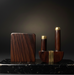 Wooden and brass objects on a dark marble surface with a dark background