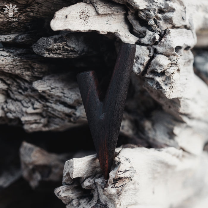 Dark metallic object embedded in a textured stone surface