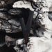 Dark metallic object embedded in a textured stone surface