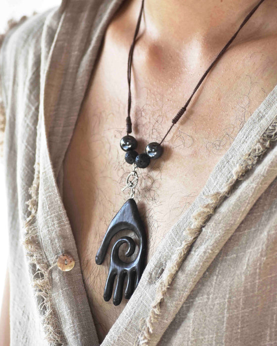 Empower your spirit with our Sacred Ebony Wood Amulet Necklace, adorned with Hematite and volcanic lava for protection and grounding. Handcrafted for beauty and spiritual reinforcement.