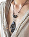 Empower your spirit with our Sacred Ebony Wood Amulet Necklace, adorned with Hematite and volcanic lava for protection and grounding. Handcrafted for beauty and spiritual reinforcement.