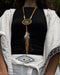 Close-up of a traditional-style dream catcher amulet with amethyst and howlite beadsx, hanging from a car mirror.