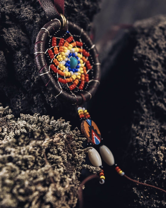 Embrace protection and style with our Ethnic-Styled Dream Catcher Amulet, handcrafted from goatskin leather. A blend of shamanic wisdom and Boho elegance, it's the perfect spiritual accessory.