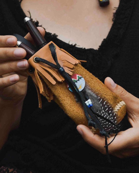 Traditionally crafted leather shamanic bag adorned with ethnic motifs, perfect for storing kuripe and hape tools, embodying the essence of ritual and tradition