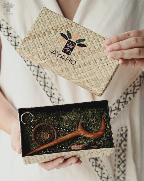 Hand-carved teak wood crescent moon clip holding a loose braid, showcasing golden-brown grain against chestnut hair.