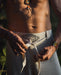Detail of unisex boho organic cotton pants featuring a distinctive sacred geometry pattern on the belt, handcrafted for a blend of style and comfort in bohemian fashion.