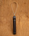 Hand-polished copper tongue cleaner with antimicrobial properties, resting on bamboo tray with fresh mint leaves.