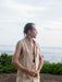 Man standing on a beach with ocean and sky in the background