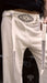 White pants with black geometric patterns and 'AYAHO' branding on a dark background
