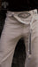 Beige pants with black geometric embroidery and a white belt, featuring the AYAHO brand.