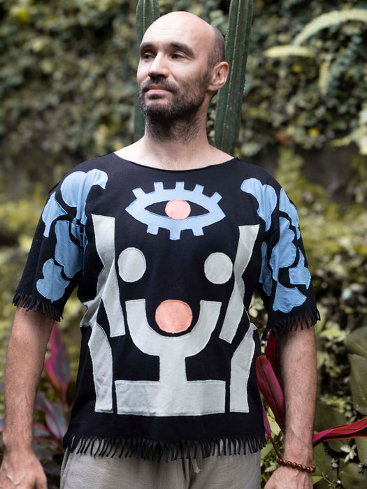 Man wearing a black t-shirt with abstract design outdoors