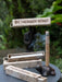 Palosanto retreat incense holder with smoke against a blurred green background