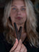 Person holding a wooden tool with a blurred background