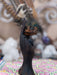 Decorative statue of a hand holding a small object against a blurred background