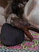Wooden tool on a black stone with a colorful fabric background