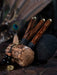 Wooden tool with a textured handle and decorative elements on a dark background