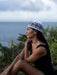 Woman sitting outdoors with a scenic background