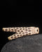 Decorative object with leopard print design on a dark background