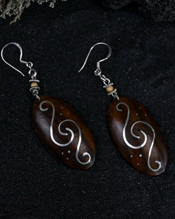 Handcrafted matching carved earrings set, embodying spiritual harmony, reflecting shamanic protection