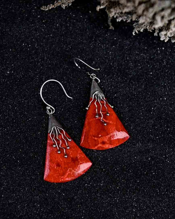 Vibrant handcrafted coral and silver earrings, representing the Awakening of Sacred Femininity imbued with energy and protection