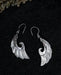 Exquisite Angel Wings earrings, crafted from lustrous mother-of-pearl and detailed sterling silver, radiating aesthetic grace and ethereal charm