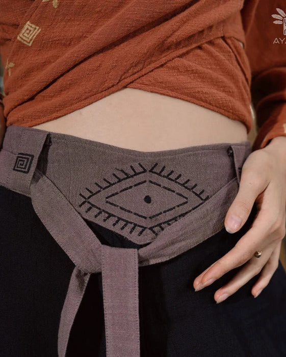 Close-up of unisex cotton pants featuring a white hand-embroidered tribal pattern, embodying Boho and shamanic styles