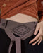 Close-up of unisex cotton pants featuring a white hand-embroidered tribal pattern, embodying Boho and shamanic styles