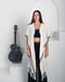Artisan-crafted poncho in boho style, made from premium natural fabrics with intricate tribal patterns – perfect for spiritual practices and outdoor gatherings.