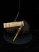 Incense stick and packaging on a dark surface