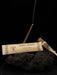 Incense sticks with a labeled package on a dark background