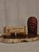 Temple incense set with packaging and wooden figure on a stone surface