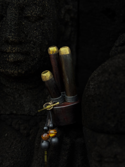 Wooden tool with gold accents on a dark textured background