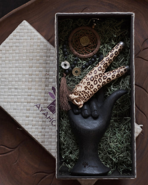Decorative item with leopard print design in a box on a textured surface