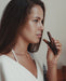 Woman holding a chocolate bar close to her face