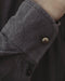 Man in a relaxed-fit brown cotton shirt with a mandarin collar, showcasing boho tribal fashion by the poolside