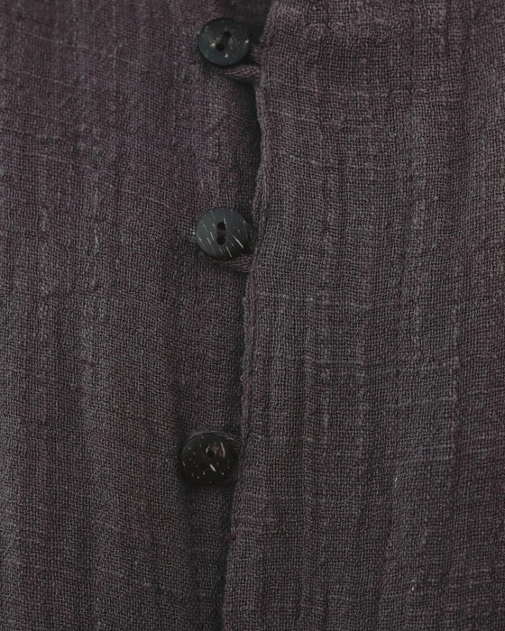Close-up of a textured dark brown fabric with buttons, featuring the Ayarial brand logo.