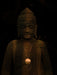 Statue of a figure with a dark background