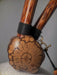 Wooden tool with a textured handle and decorative head on a neutral background